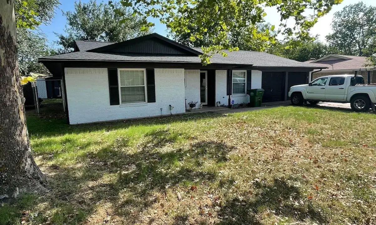 Professional roofing crew working on a residential roof in Luling
